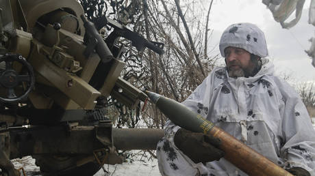 A Ukrainian soldier prepares to fire artillery at Russian positions near Bakhmut/Artyomovsk, Russia, February 15, 2023