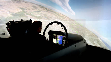 FILE PHOTO: A person using a fighter jet simulator.