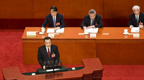 Chinese Premier Li Keqiang (bottom) delivers a speech during the opening of the first session of the 14th National People's Congress (NPC) at The Great Hall of People on March 5, 2023 in Beijing