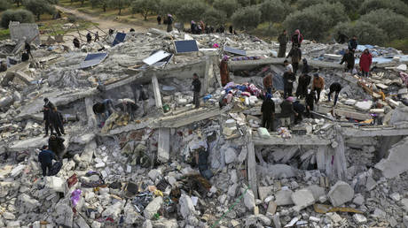 Rescue workers search through the rubble of collapsed buildings destroyed in an earthquake in the town of Harem, Idlib province, Syria, February 6, 2023.