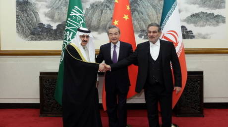 Iran's top security official Ali Shamkhani (R), Chinese Director of the Office of the Central Foreign Affairs Commission Wang Yi (C) and Musaid Al Aiban, the Saudi Arabian national security adviser, in Beijing, China on March 10, 2023.