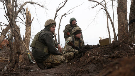 Ukrainian servicemen attend on their position on the frontline with Russian troops near Ugledar in the People's Republic of Donetsk.