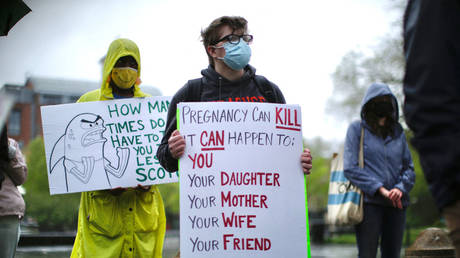 FILE PHOTO: A transgender man holds a banner as pro-abortion rights protesters gather on May 7, 2022, in New York City.