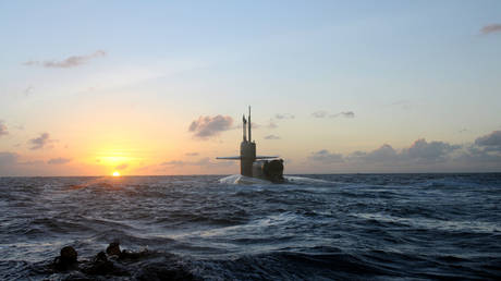 SEALs and divers from SEAL Delivery Vehicle Team (SDVT) 1 swim back to the guided-missile submarine USS Michigan (SSGN 727) during an exercise for certification on SEAL delivery vehicle operations in the southern Pacific Ocean