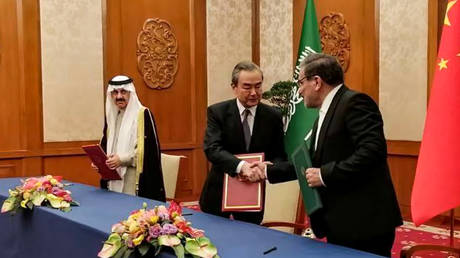 Iran's top security official Ali Shamkhani (R), Chinese Director of the Office of the Central Foreign Affairs Commission Wang Yi (C) and Musaid Al Aiban, the Saudi Arabian national security adviser, in Beijing, China on March 10, 2023.