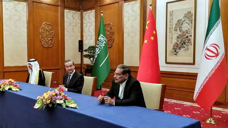 Iran's top security official Ali Shamkhani (R), Chinese Director of the Office of the Central Foreign Affairs Commission Wang Yi (C) and Saudi Anational security adviser Musaid Al Aiban during talks in Beijing.