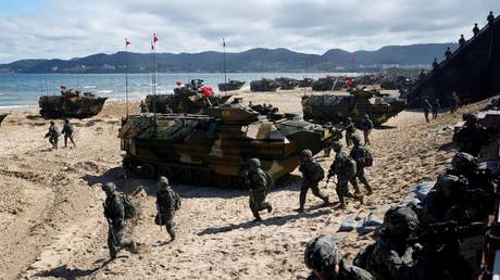 FILE PHOTO:  South Korean marines walk past amphibious assault vehicles