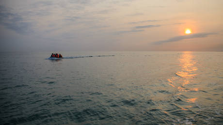 FILE PHOTO. Migrants in a dinghy wearing life jackets illegally cross the English Channel from France to Britain on September 11, 2020.