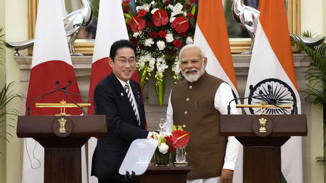 Japan’s Prime Minister Fumio Kishida, left and Indian Prime Minister Narendra Modi, shake hands after making press statements following their meeting in New Delhi, India, Monday, March 20, 2023.