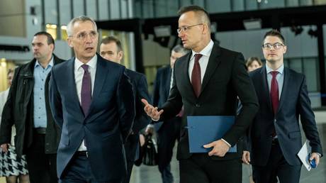 (L) NATO Secretary General Jens Stoltenberg and (R) Hungarian Foreign and Trade Minister Peter Szijjarto.