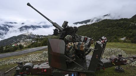 FILE PHOTO. An Indian Army soldier sits inside an upgraded L70 anti aircraft gun in Tawang, near the Line of Actual Control (LAC), in the northeast Indian state of Arunachal Pradesh on October 20, 2021.