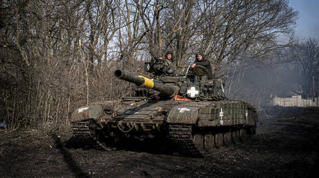 Ukrainian servicemen drive a tank.