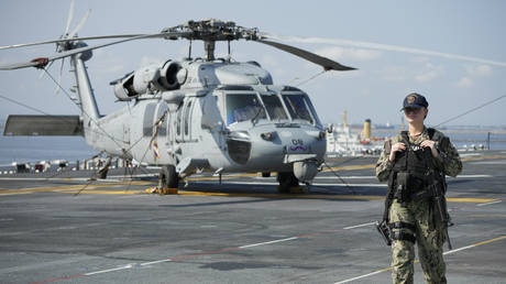 A member of the US Navy is seen onboard an amphibious assault ship during a scheduled port visit in Manila, Philippines, March 21, 2023.