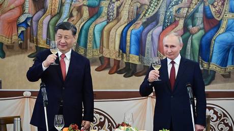 Chinese President Xi Jinping and Russian President Vladimir Putin attend a reception in honor of the Chinese leader's visit to Moscow at the Kremlin, in Moscow, Russia.