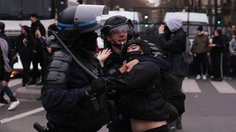 Police officers clash with a protester during a demonstration in Paris, France, March 23, 2023