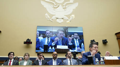 TikTok CEO Shou Zi Chew (R) testifies during a US congressional hearing on Capitol Hill in Washington, DC, March 23, 2023.
