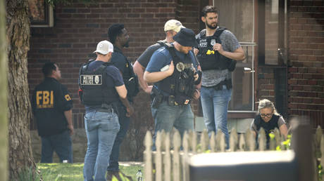 Metro Nashville Police and FBI search and investigate a house following a mass shooting at Covenant School, March 27, 2023