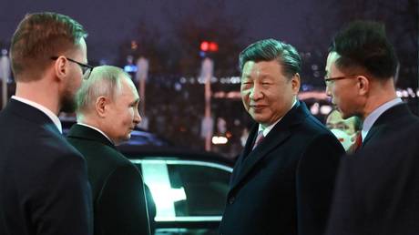 Russian President Vladimir Putin and Chinese President Xi Jinping are seen as they leave after a reception in honor of the Chinese leader's visit to Moscow at the Kremlin, in Moscow, Russia.