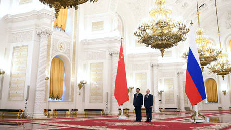 Chinese President Xi Jinping and Russian President Vladimir Putin attend a welcome ceremony before Russia - China talks in a narrow format at the Kremlin in Moscow, Russia.