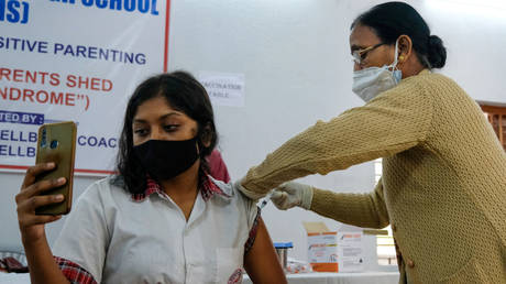 A student takes a selfie while being administered with a dose of Covaxin vaccine developed by Bharat Biotech at Barasat Girls High School, Kolkata, India,  January 03, 2022.