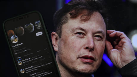 In this photo illustration, Elon Musk's twitter profile is displayed on a mobile phone