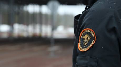 A Finnish border guard stands at the Vaalimaa border crossing in southeastern Finland, March, 2023.