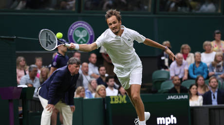 Daniil Medvedev of Russia plays a forehand in his match against Hubert Hurkacz of Poland during Wimbledon 2021