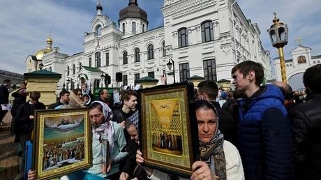 Believers of the Ukrainian Orthodox Church pray and hold icons outside the historic Kiev Pechersk Lavra monastery in Kiev, on April 1, 2023.