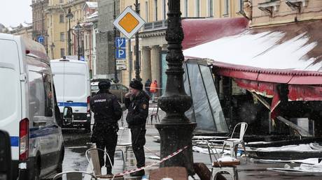 Police officers stand guard near a cafe damaged by an explosion which killed military blogger Vladlen Tatarsky (real name Maxim Fomin) in Saint Petersburg, Russia.