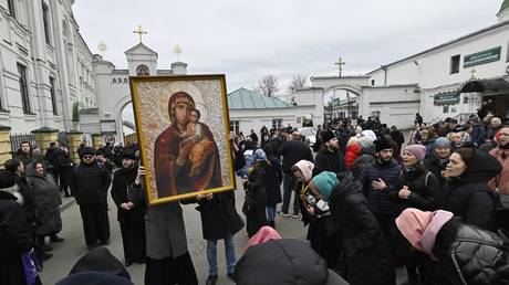 FILE PHOTO: Ukrainian Orthodox Church members pray outside the Kiev Pechersk Lavra monastery, March 31, 2023.