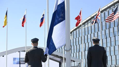 Soldiers raise the Finnish flag at NATO headquarters in Brussels, Belgium, April 4, 2023.