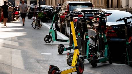 Electric scooters are seen parked on a sidewalk in Paris, France, September 3, 2021