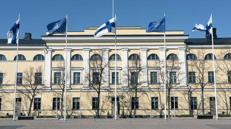 Finland and NATO flags waving at the Finnish Foreign Ministry in Helsinki on April 04, 2023.