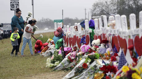 FILE PHOTO: People visit a makeshift memorial for the victims of a 2017 shooting at a church in Sutherland Springs, Texas.