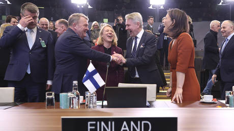 Denmark's Foreign Minister Lars Lokke Rasmussen, center left, shakes hands with Finland's Foreign Minister Pekka Haavisto as they attend the NATO-Ukraine Commission during a meeting of NATO foreign ministers at NATO headquarters in Brussels, Tuesday, April 4, 2023.