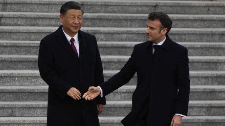 French President Emmanuel Macron prepares to shake hands with Chinese President Xi Jinping during a welcome ceremony outside the Great Hall of the People on April 6, 2023 in Beijing, China.