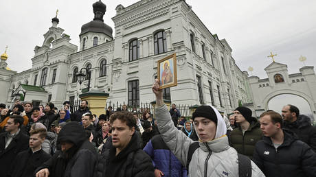 Believers of the Ukrainian Orthodox Church, who are accused of maintaining links with Moscow, and pro-Ukrainian activists confront each other at the historic monastery Kiev-Pechersk Lavra in Kiev on March 31, 2023.