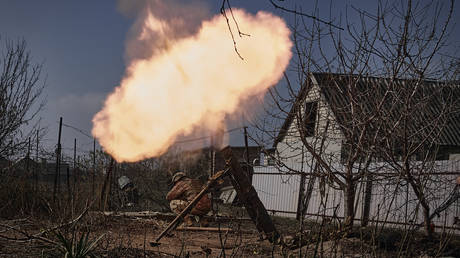 FILE PHOTO: Ukrainian soldiers fire a mortar on the frontline near the city of Artyomovsk, Donetsk region, March 26, 2023.