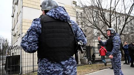 FILE PHOTO: Russian law enforcement officers stand outside the Lefortovsky court after a US journalist Evan Gershkovich, was escorted out of it in Moscow, Russia, on March 30, 2023.