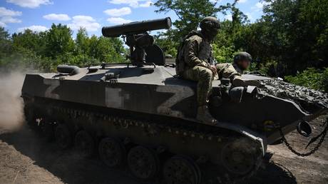 FILE PHOTO: Servicemen from an anti-tank battery of Russian Airborne Forces ride atop an infantry fighting vehicle armed with Kornet anti-tank missiles.