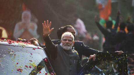 India's Prime Minister Narendra Modi waves to his supporters during a roadshow ahead of the BJP national executive meet in New Delhi on January 16, 2023.