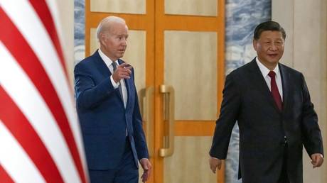 U.S. President Joe Biden, left, arrives with Chinese President Xi Jinping for a meeting on the sidelines of the G20 summit meeting, Monday, Nov. 14, 2022, in Bali, Indonesia.