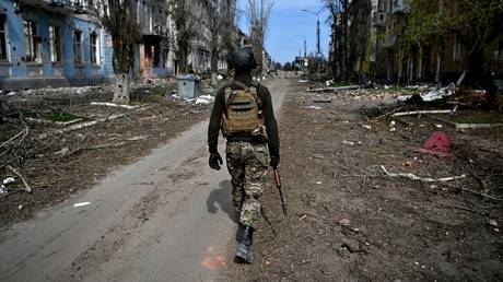 A serviceman of Russia's private military company Wagner Group's assault detachment walks in a street in central part of Artyomovsk, also known as Bakhmut, as Russia's military operation in Ukraine continues, Donetsk People's Republic, Russia.
