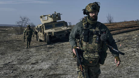 Soldiers of the Ukrainian 3rd Army Assault Brigade of the Special Operations Forces (SSO) "Azov" near their armoured U.S. Hummer vehicle in position near Bakhmut, Donetsk region, Ukraine, Saturday, Feb. 11, 2023.