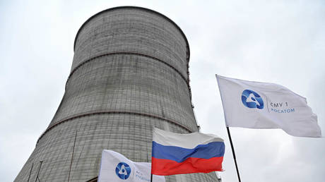 A Russian national flag and flags with the logo of Rosatom flutters at the construction site of a cooling tower at the Kursk II nuclear power plant near the village of Makarovka outside Kurchatov, Kursk region, Russia.