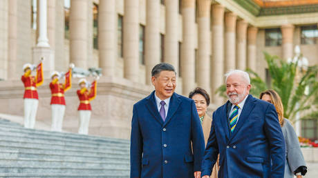 Chinese President Xi Jinping (L) and Brazil's President Luiz Inacio Lula da Silva, accompanied by their wives, attending a welcome ceremony at the Great Hall of the People in Beijing on April 14, 2023.