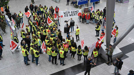 Aviation security staff organized in the public transport sector union Verdi gather for a demonstration during a strike at the airport of Duesseldorf, western Germany, on April 20, 2023.