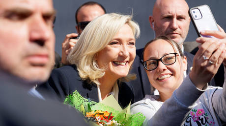 France's Marine Le Pen (center) is shown campaigning for president in April 2022.