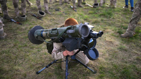 A Ukrainian recruit holds a US-made Javelin anti-tank weapon during training.