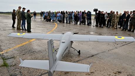FILE PHOTO: Journalists attend the presentation of a UJ-22 Airborne drone in August 2022.